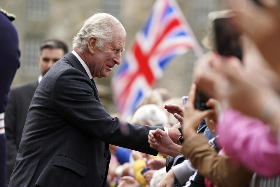 FILE - Britain's King Charles III meets members of the public during his visit to Kinneil House in Edinburgh, Scotland, Monday, July 3, 2023. Two months after the lavish coronation of King Charles III at Westminster Abbey in London, Scotland is set to host its own event to mark the new monarch’s accession to the throne. While Charles won’t have a separate coronation Wednesday in Edinburgh, the festivities will include a crown, horse-drawn carriages, mounted cavalry and a flyover by the Red Arrows, the Royal Air Force’s aerobatic display team, as Scotland celebrates its unique relationship with the monarchy. (Andrew Milligan/Pool Photo via AP, File)