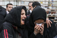 This picture provided by ISNA, a semi-official news agency, taken on Tuesday, April 15, 2014 shows Kobra, left, whose son Bilal was convicted of murdering a man, embracing Samereh Alinejad, mother of the victim, after she pardoned the murderer before his execution in public in the northern city of Nour, Iran. Bilal who was convicted of killing Abdollah Hosseinzadeh, was pardoned by the victim's family moments before being executed. (AP Photo/ISNA, Arash Khamoushi)