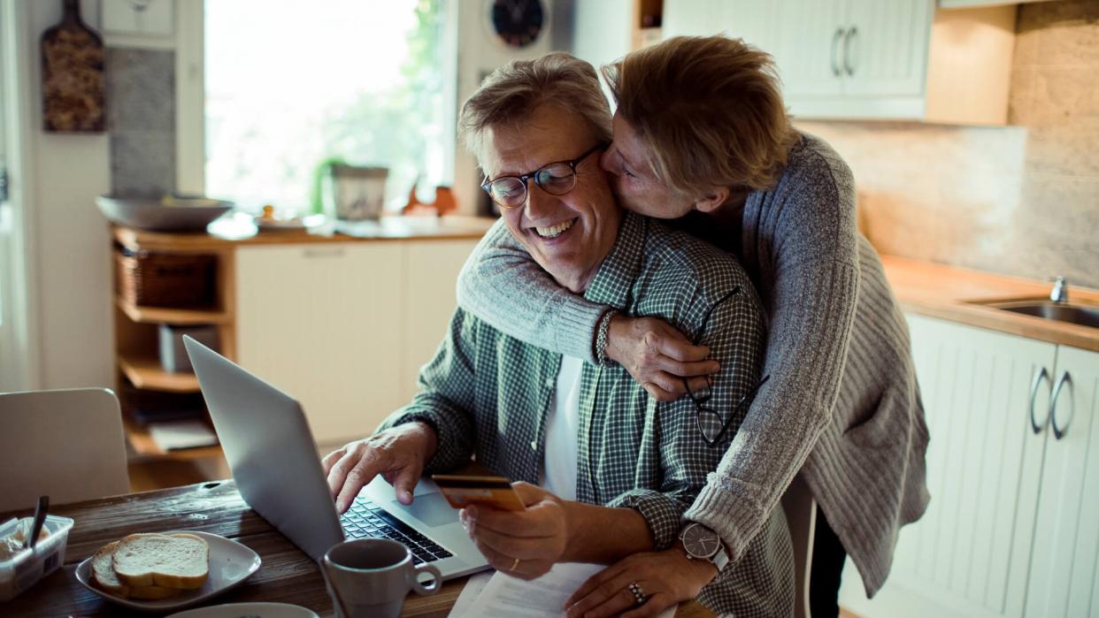 Close up of a mature couple doing online shopping in the morning.