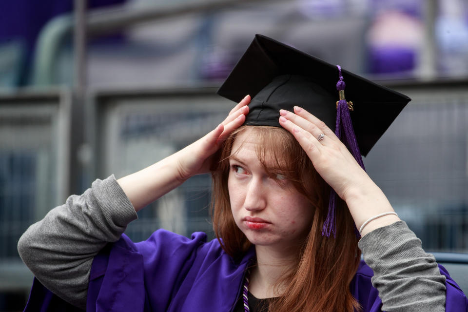 NEW YORK, NY - MAY 16: A student adjusts her cap as she waits for the start of New York University's commencement ceremony at Yankee Stadium, May 16, 2018 in the Bronx borough of New York City. Canadian Prime Minister Justin Trudeau, who was honored with a honorary doctor of laws degree, is delivering a commencement address to the graduating class of 2018. (Photo by Drew Angerer/Getty Images)