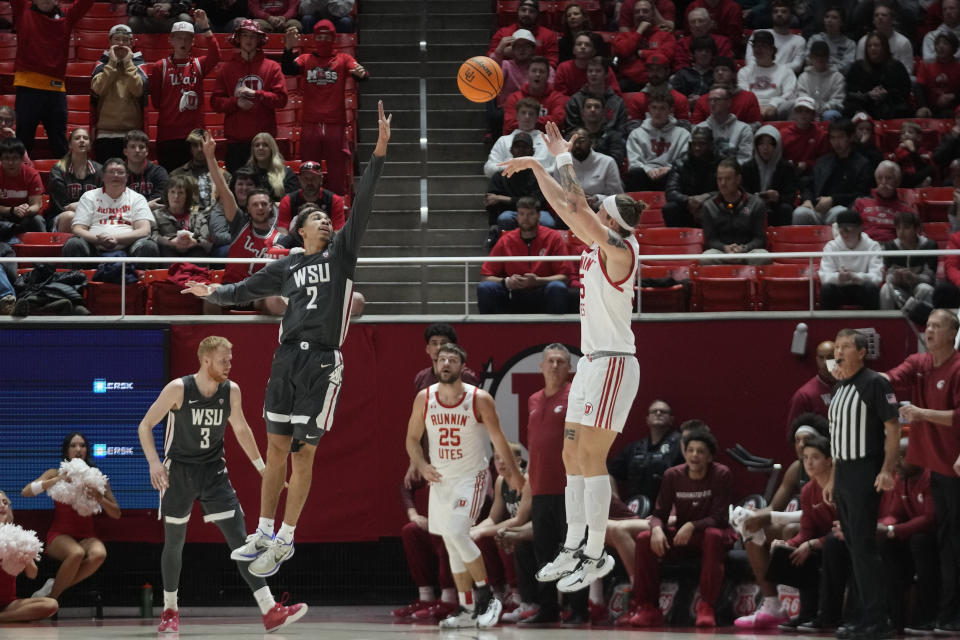 Utah guard Gabe Madsen, center right, shoots as Washington State guard Myles Rice (2) defends during the first half of an NCAA college basketball Friday, Dec. 29, 2023, in Salt Lake City. (AP Photo/Rick Bowmer)