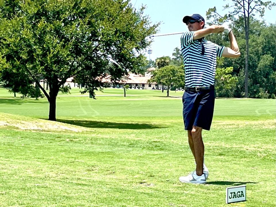 Jeff Dennis watches his tee shot at the par-3 eighth hole of the San Jose County Club during the second round of the Jacksonville Amateur.  Dennis leads by two shots entering Saturday's final round.