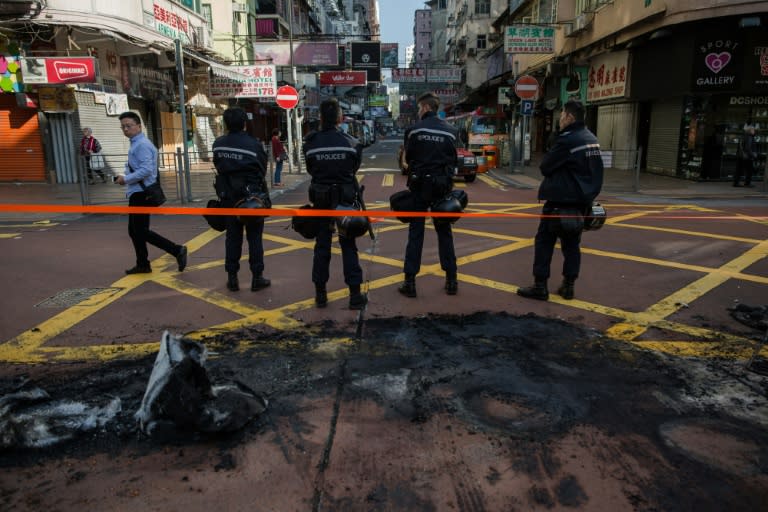 Baton-wielding Hong Kong riot police fired warning shots and tear gas early on February 9 after a riot erupted in the busy district of Mongkok when officials tried to shift illegal hawkers