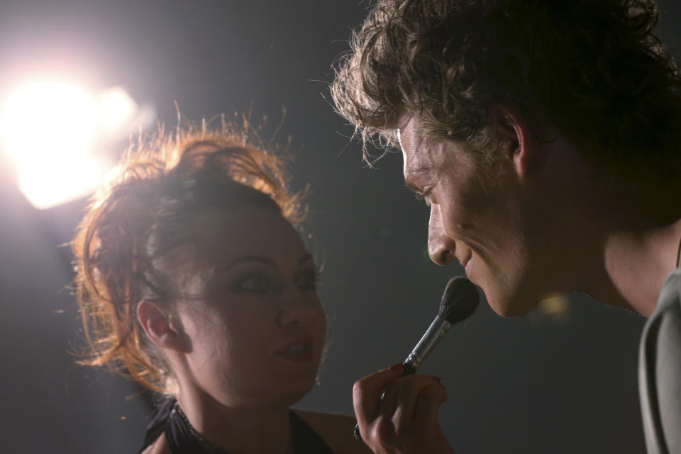 A model goes through make up in the backstage prior to the start of the Vivienne Westwood men's Spring-Summer 2014 fashion collection, part of the Milan Fashion Week, unveiled in Milan, Italy, Sunday, June 23, 2013. (AP Photo/Luca Bruno)