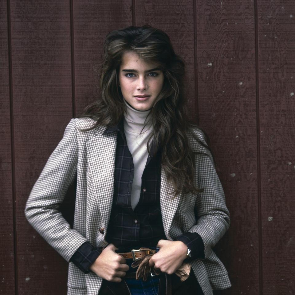 <p>Brooke Shields poses in a turtleneck and checked blazer. </p>