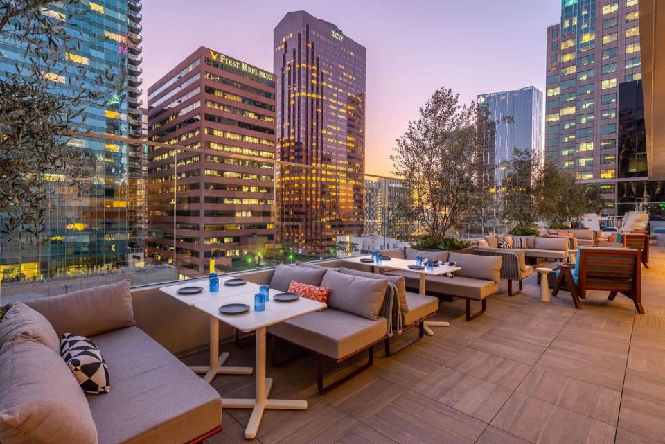 <p><a href="https://www.wayfarerdtla.com/downtown-la-dining/rooftop" rel="nofollow noopener" target="_blank" data-ylk="slk:The Rooftop" class="link ">The Rooftop</a> at The Wayfarer is a pretty chill place to hang out, thanks to its comfy booths and laid-back feel. It’s also open for brunch, lunch, dinner, and as a bar—so you can enjoy the LA skyline whenever you please. </p><p><strong><a href="https://www.google.com/maps/reviews/@34.0471338,-118.2606329,17z/data=!3m1!4b1!4m6!14m5!1m4!2m3!1sChdDSUhNMG9nS0VJQ0FnSURXZ0tfYnFnRRAB!2m1!1s0x0:0x7c6600fad4b5592c?hl=en-US" rel="nofollow noopener" target="_blank" data-ylk="slk:Glowing review" class="link ">Glowing review</a></strong>: "What a fun rooftop dining and bar experience right in downtown LA! As a cookbook author, I always enjoy eating out and appreciate good food, nicely plated. The Rooftop did not disappoint."</p>