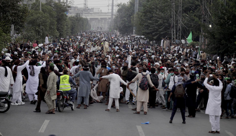 Supporters of Tehreek-e-Labiak Pakistan, a radical Islamist political party, march toward Islamabad, in Lahore, Pakistan, Friday, Oct. 22, 2021. Thousands of Islamists launched their "long march" from the eastern city of Lahore toward Pakistan's capital, demanding that the government release the leader of their Saad Rizvi, who was arrested last year amid demonstrations against France over publishing caricatures of Islam's Prophet Muhammad. (AP Photo/K.M. Chaudary)