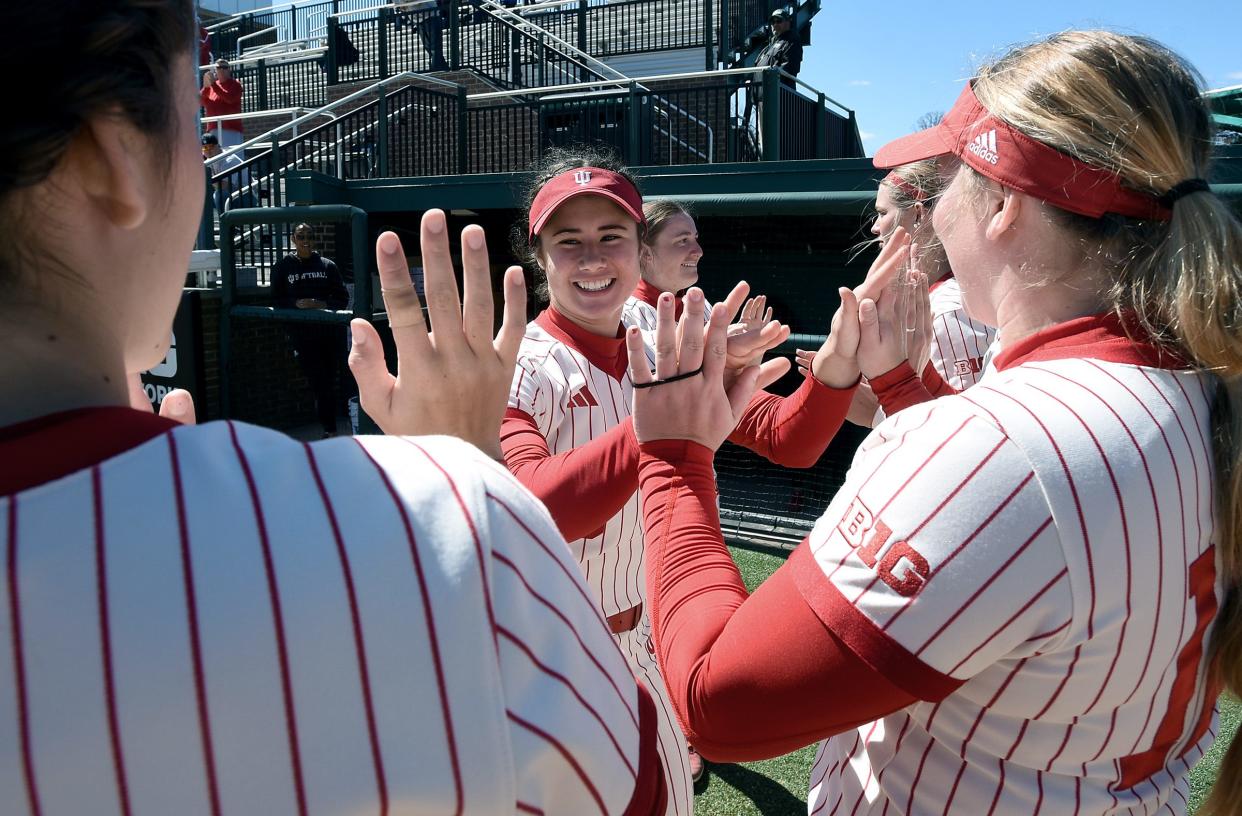 Indiana University freshman Aly VanBrandt, former player for the Whiteford Bobcats, greeted by her teammates as the starting line-up was introduced at Michigan State University Saturday, April 6, 2024. VanBrandt bats in the fifth spot of the line-up.