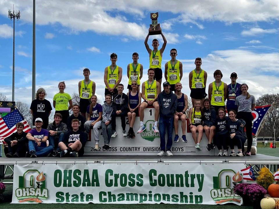 Everyone associated with the Mount Gilead cross country program poses with the Division III state championship boys team atop the podium during the state meet at Fortress Obetz this fall.