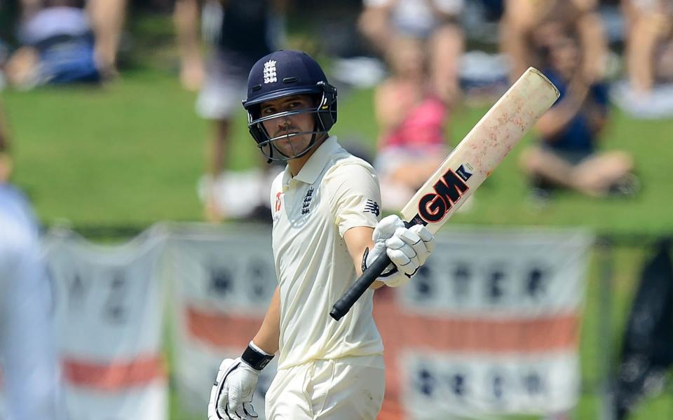 England's Rory Burns raises his bat to the crowd after scoring a half-century (50 runs) during the third day of the second Test match between Sri Lanka and England at the Pallekele International Cricket Stadium in Kandy on November 16, 2018. - ISHARA S. KODIKARA / AFP)ISHARA S. KODIKARA/AFP/Getty Images