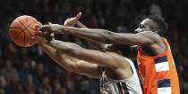 Virginia Tech's P.J. Horne (14) is fouled from behind by Syracuse's Bourama Sidibe (34) as they battle for a rebound during the first half of an NCAA college basketball game in Blacksburg Va., Saturday, Jan. 18 2020. (Matt Gentry/The Roanoke Times via AP)