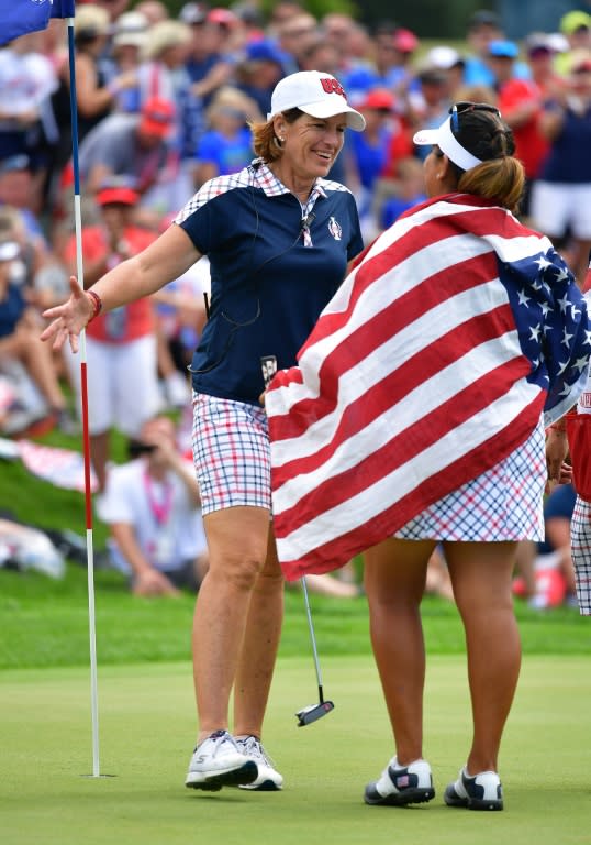 Juli Inkster, Captain of Team USA, celebrates with Lizette Salas on the 18th hole during the final day singles matches of The Solheim Cup on August 20, 2017