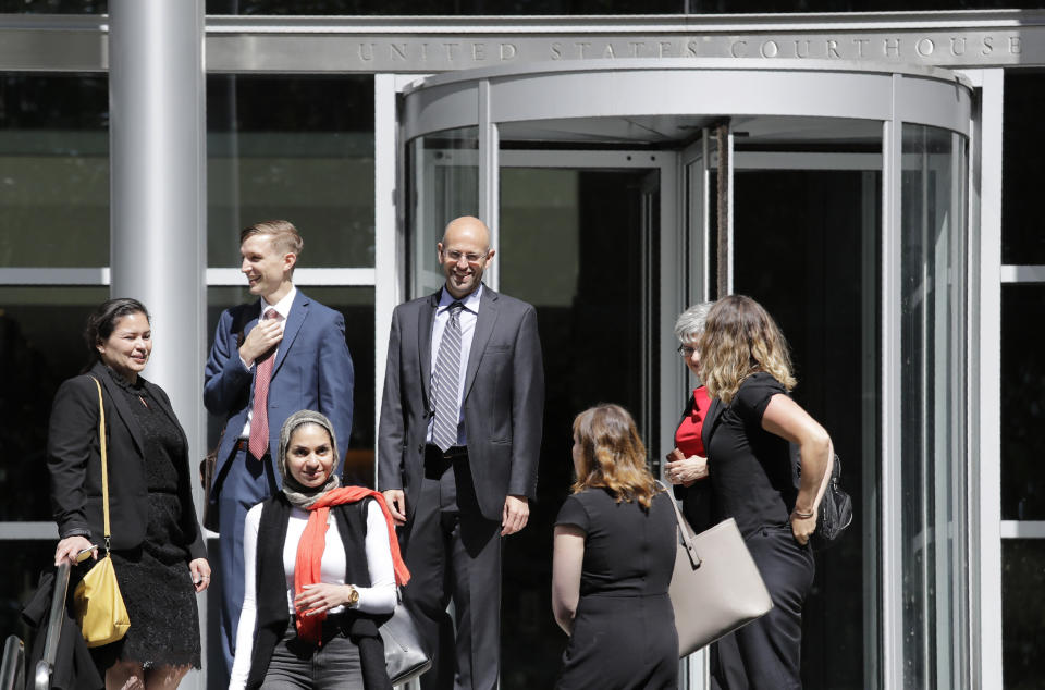 Matt Adams, center right, Legal Director of the Northwest Immigrant Rights Project, leaves the U.S. Courthouse with others after a hearing on asylum seekers there Friday, June 28, 2019, in Seattle. A federal judge heard a challenge to a new Trump administration policy, scheduled to take effect next month, that would keep thousands of asylum seekers locked up while they pursue their cases, instead of allowing them to be released on bond. It targets immigrants who have recently entered the U.S. without permission and have demonstrated a credible fear of persecution or torture if returned to their home country. (AP Photo/Elaine Thompson)