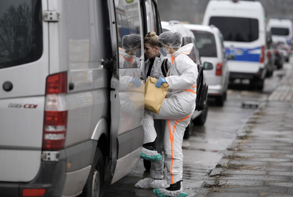 Investigators secure evidence from a Jehovah's Witness building in Hamburg, Germany Friday, March 10, 2023. Shots were fired inside the building used by Jehovah's Witnesses in the northern German city of Hamburg on Thursday evening, with multiple people killed and wounded, police said. (AP Photo/Markus Schreiber)