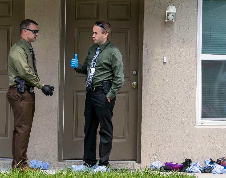 This photo shows two detectives talking outside the residence once shared by Deangelo Leandrew Shelton Clark and Kiara Alleyne the morning of Sept. 11, 2019.