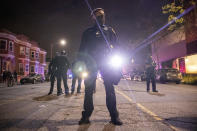 Oakland police officers line the street as demonstrators confront the officers during a protest against police brutality in Oakland, Calif., on Friday, April 16, 2021. (AP Photo/Ethan Swope)