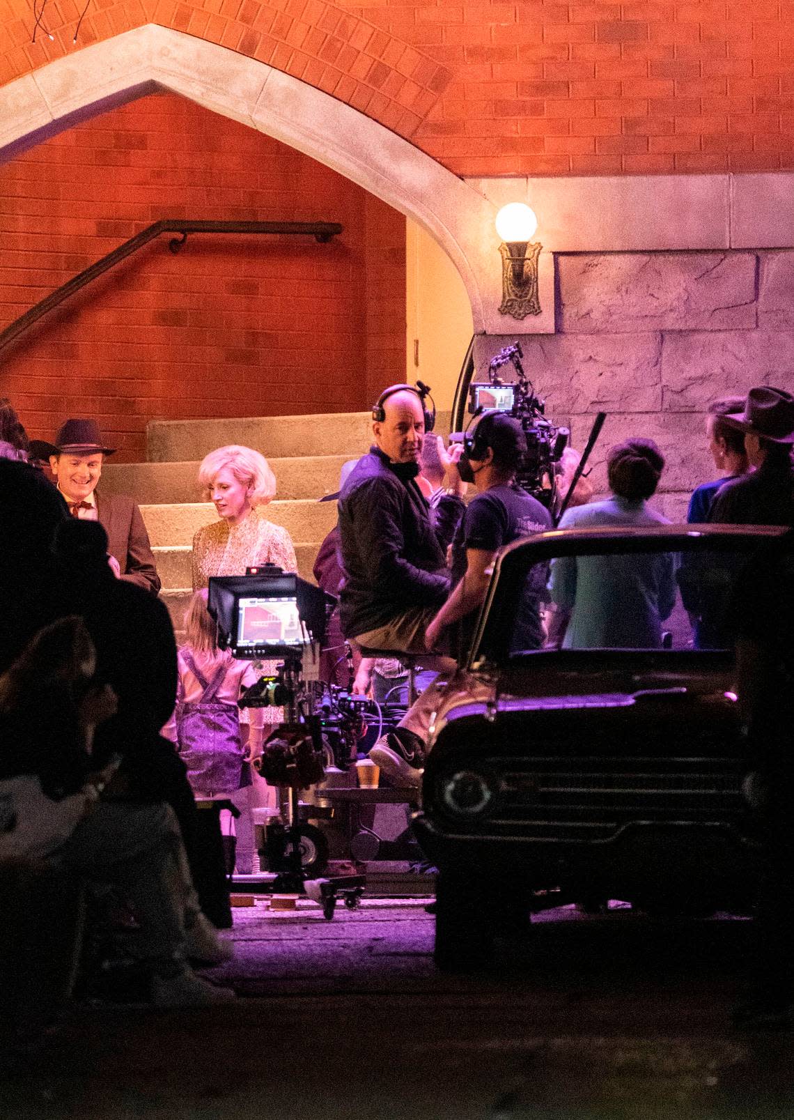 A production crew films a scene for “George and Tammy,” a television series about country music stars George Jones and Tammy Wynette, played by Michael Shannon and Jessica Chastain, far left, in downtown Wilmington, N.C. on Friday, March 18, 2022.