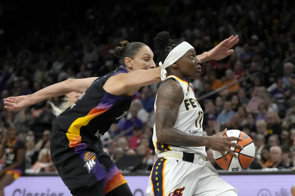 Indiana Fever guard Erica Wheeler, right, drives past Phoenix Mercury guard Diana Taurasi, left, during the first half of a WNBA basketball game Sunday, June 30, 2024, in Phoenix. (AP Photo/Ross D. Franklin)