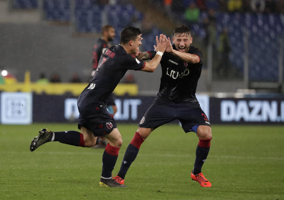 Bologna's Riccardo Orsolini, left, celebrates with Bologna's Giancarlo Gonzalez after scoring his side's third goal during an Italian Serie A soccer match between Lazio and Bologna, at the Olympic stadium in Rome, Monday, May 20, 2019. (AP Photo/Andrew Medichini)