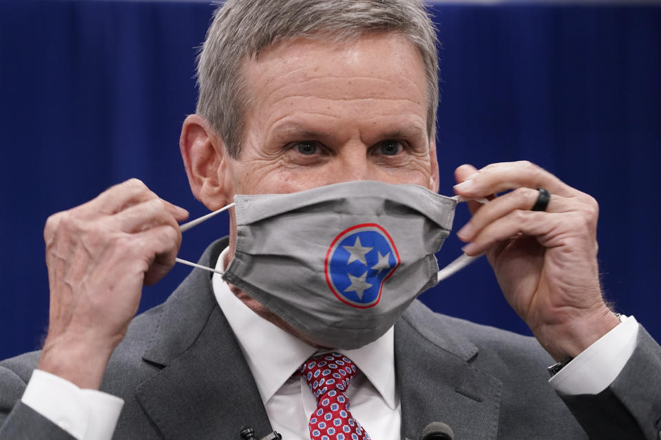 Tennessee Gov. Bill Lee puts on his mask during a break in the state budget hearings Tuesday, Nov. 10, 2020, in Nashville, Tenn. According to a Vanderbilt University School of Medicine study released Tuesday, Tennessee counties that have not required wearing masks in public are on average seeing COVID-19 death rates double or more compared with those that instituted mandates. Lee has opposed a statewide mask mandate, stressing personal responsibility. He has instead allowed counties to decide whether to require masks. (AP Photo/Mark Humphrey)