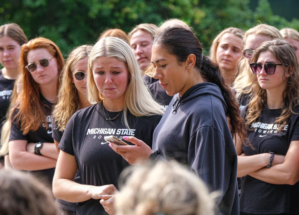 Emily Petrosky, left, and Erica McIntee, friends and rowing team members, share their thoughts of Olivia Long at a dedication of a new boat in her honor Saturday, Sept. 17, 2022.