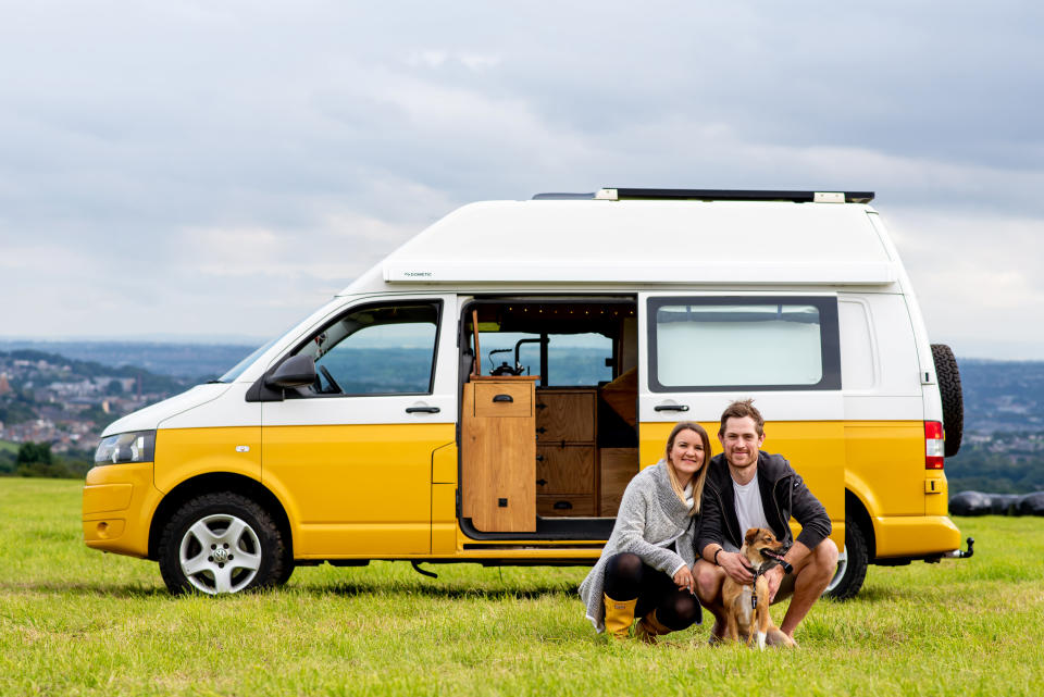 Kate and Steve Kennedy in front of their campervan with their dog