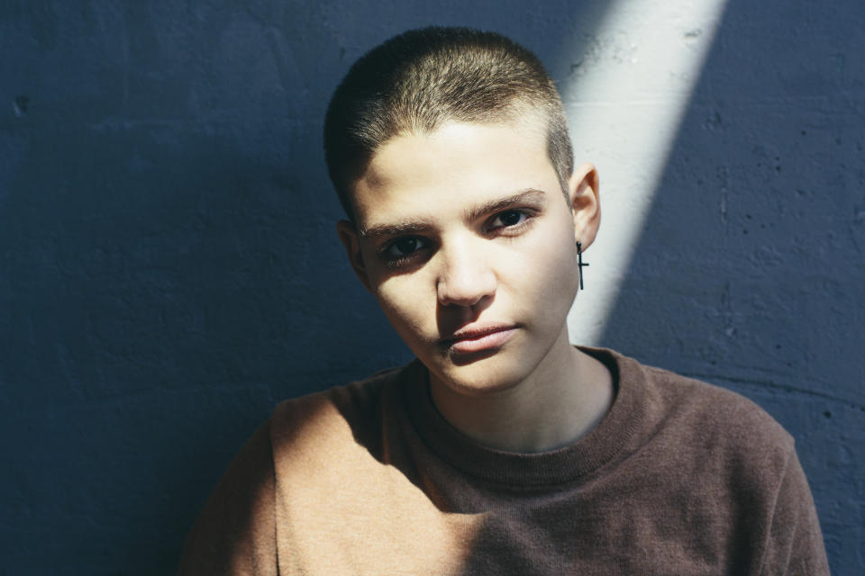 Portrait Of Young Adult Woman With Shaved Head