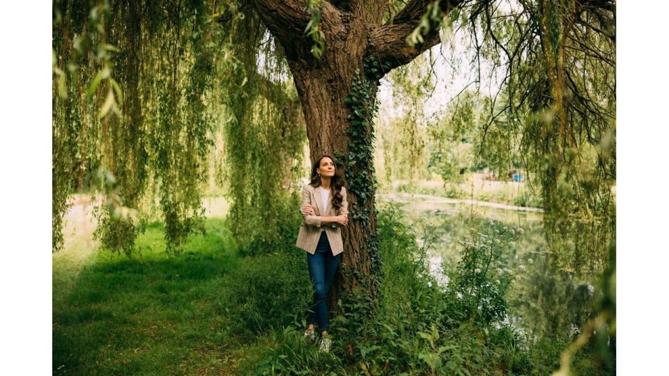 Kate Middleton standing next to tree