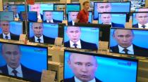 TV screens in a shop in Moscow show President Vladimir Putin's televised question and answer session