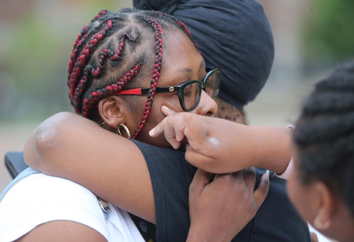 Marquetta Williams, left, embraces Jolanda Jackson, right, as Marquetta's daughter Ja'Lia Williams wipes away her mother's tears as they all remembered the life of James R. Williams, Marquetta's late husband, in Canton on Saturday. Williams was shot and killed by Canton police on New Year's Day.