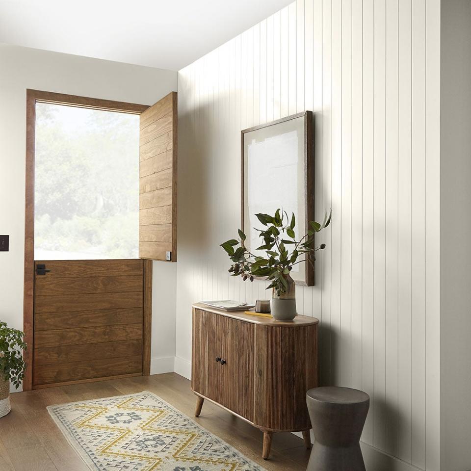 Entryway with wooden door in Behr's color of the year, 