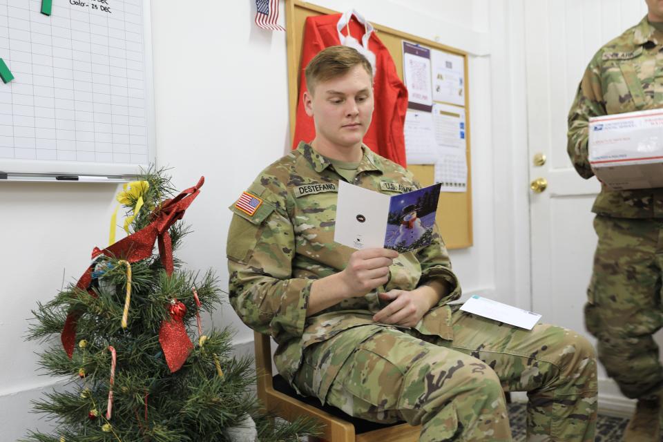 While deployed to Camp Bondsteel, Kosovo, in support of Operation Joint Guardian, Specialist Dante Destefano, Task Force Nighthawk, 76 Infantry Brigade Combat Team, Indiana Army National Guard, takes a few minutes to read a Christmas card sent from back home, December 21, 2022. Destafano is a cable installer and maintainer for the Indiana National Guard.
