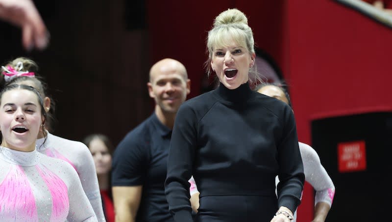 University of Utah gymnast coach Carly Dockendorf cheers a gymnast in Salt Lake City on Friday, Feb. 23, 2024. Dockendorf has used social media often this season, praising her gymnasts publicly. It is to better connect with them, she says.