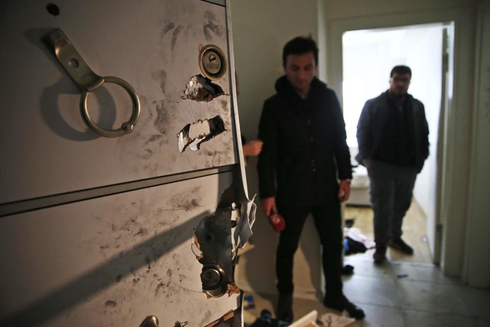 Members of the media and police stand inside the flat where a suspect of New Year's Day nightclub attack was arrested in Istanbul, Tuesday, Jan. 17, 2017. Turkish police said they captured the gunman who carried out the deadly New Year's nightclub attack in Istanbul, with officials saying Tuesday that he's an Uzbekistan national who trained in Afghanistan and confessed to the massacre. (AP Photo/Lefteris Pitarakis)