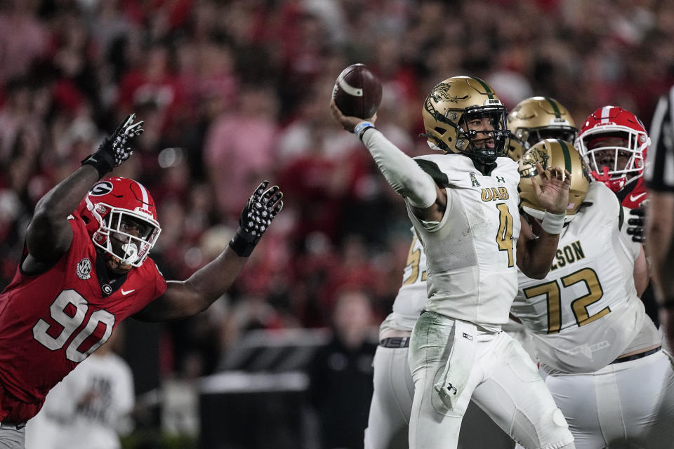 UAB quarterback Jacob Zeno (4) throws under ppressure from Georgia defensive lineman Tramel Walthour (90) during the second half of an NCAA college football game, Saturday, Sept. 23, 2023, in Athens, Ga. (AP Photo/John Bazemore)