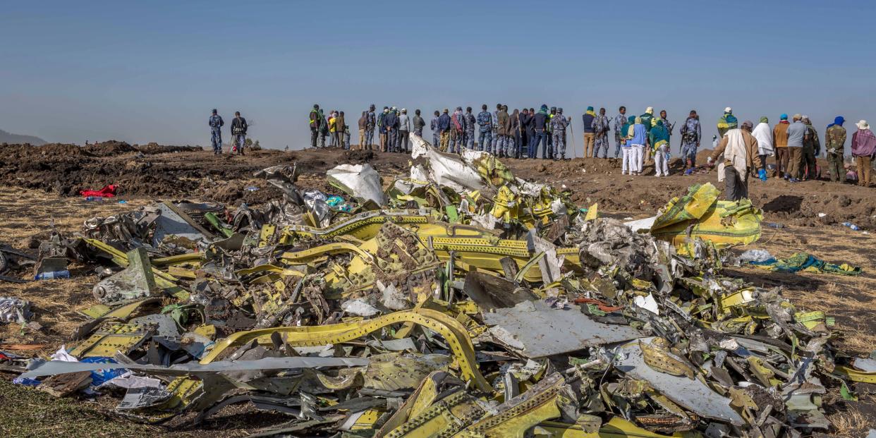 FILE - In this March 11, 2019, file photo, wreckage is piled at the crash scene of Ethiopian Airlines flight ET302 near Bishoftu, Ethiopia. The year since the crash of an Ethiopian Airlines Boeing 737 Max has been a journey through grief, anger and determination for the families of those who died, as well as having far-reaching consequences for the aeronautics industry as it brought about the grounding of all Boeing 737 Max 8 and 9 jets, which remain out of service. (AP Photo/Mulugeta Ayene, File)