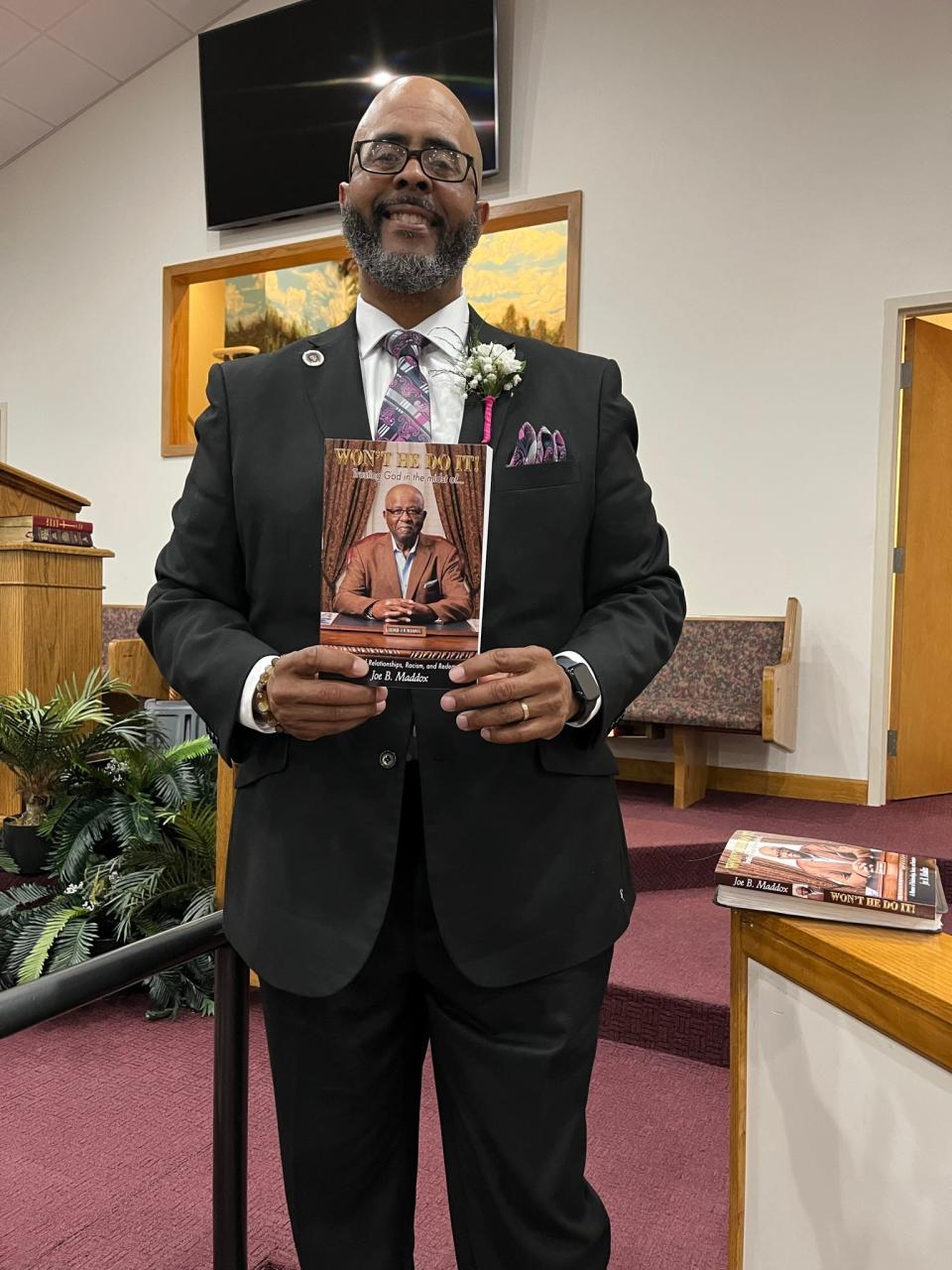 Pastor Joe B. Maddox was recently honored as an author and for his 37 years as minister at New Hope Missionary Baptist Church. Here, his nephew Timothy Maddox – assistant pastor at New Hope – proudly holds his uncle’s book.