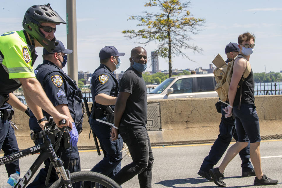 Protesters are arrested for blocking traffic on the FDR Drive while marching through Harlem during a solidarity rally for George Floyd, Saturday, May 30, 2020, in New York. Floyd died after Minneapolis police officer Derek Chauvin pressed his knee into his neck for several minutes even after he stopped moving and pleading for air. (AP Photo/Mary Altaffer)