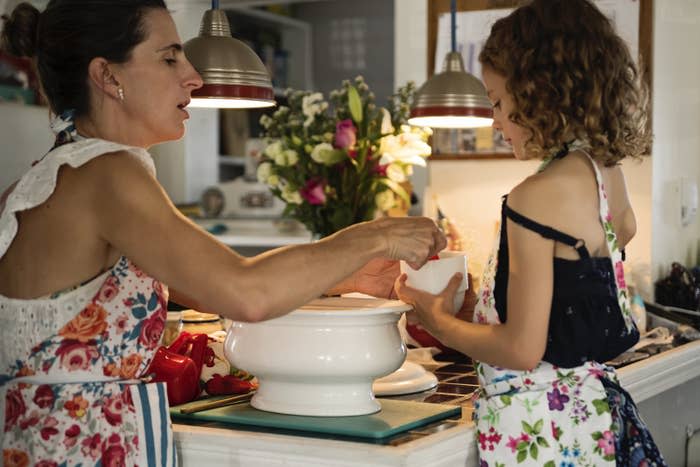 A mother and daughter cooking in the kitchen together