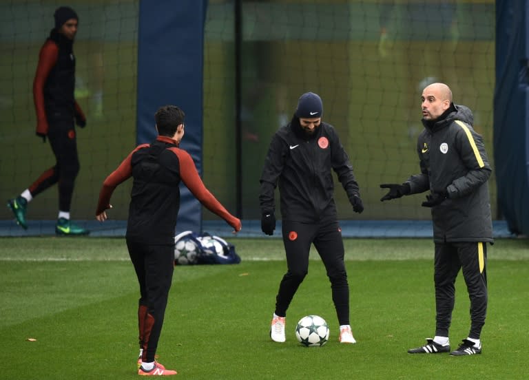 Manchester City's Spanish football coach Pep Guardiola (R) shares a joke with Jesus Navas (L) and Nolito during a training session at the City Football Academy in Manchester, northern England, on November 22, 2016