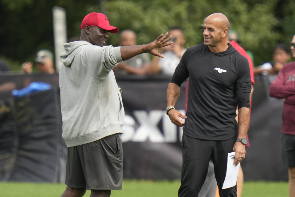 With his Bucs set to face the Jets this weekend in the preseason, head coach Todd Bowles (left) keeps pushing off a decision on his Week 1 starting quarterback. (AP Photo/Seth Wenig)