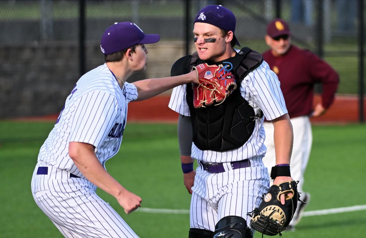 Bloomington South’s Xavier Hemingway (left) celebrates with Ben Ridner after tagging Bloomington North’s Cole Grupenhoff along the third base line during the baseball game at South on Thursday, April 25, 2024.
