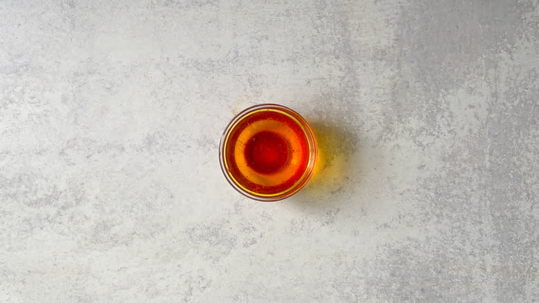 Ground saffron steeping in water in bowl