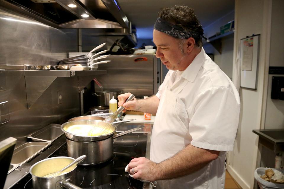 Vino e Vivo chef Paul Callahan prepares part of a 5-course meal for a chef’s table dinner.