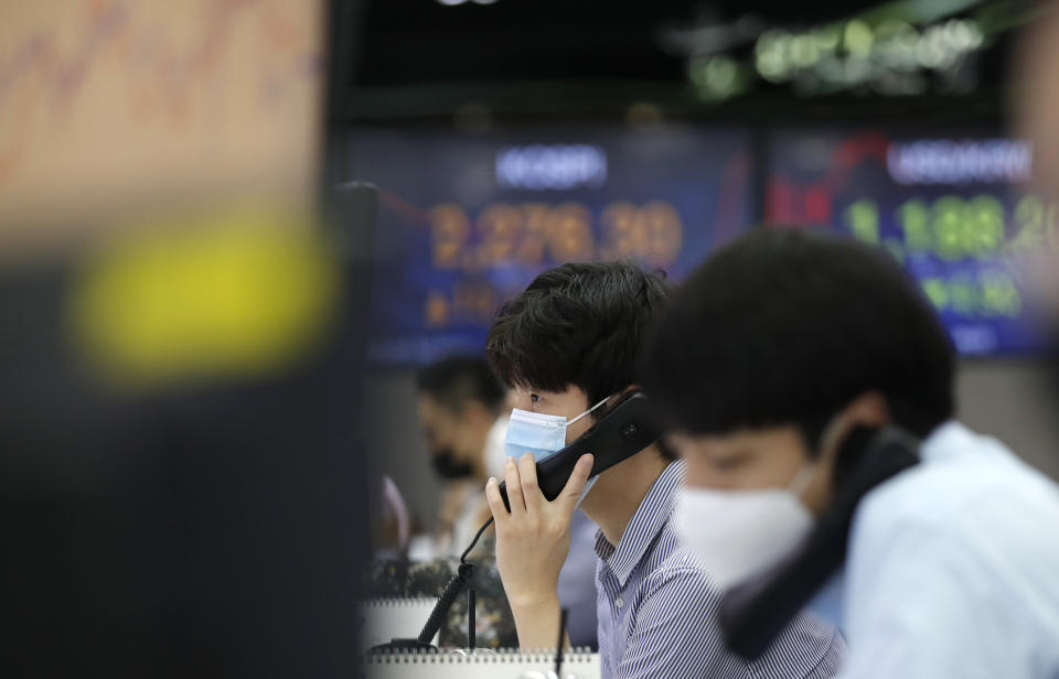 A currency trader talks on the phone at the foreign exchange dealing room in Seoul, South Korea, Thursday, July 30, 2020. Asian stocks advanced Thursday after the U.S. Federal Reserve left interest rates near zero to support a struggling economy.(AP Photo/Lee Jin-man)