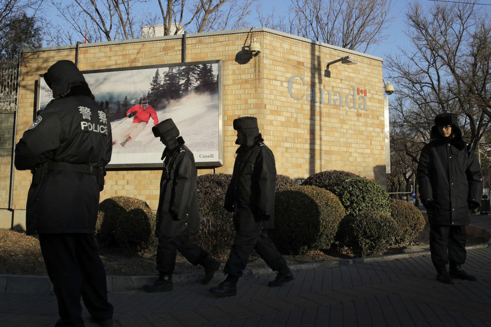 FILE - In this Dec. 12, 2018, file photo, policemen patrol outside the Canadian Embassy in Beijing. China on Thursday, Sept. 5, 2019, has urged Canada to "reflect on its mistakes" and immediately release a Huawei executive detained in Vancouver. (AP Photo/Andy Wong, File)