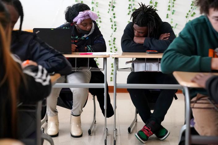 Shamara Kennedy, left, and Kendall Marcus-Riley, right, go over a class exercise during a lesson on Ohio House Bill 616 in Bethany Cole&#39;s 11th-grade social studies class, Monday, April 18, 2022, at Aiken High School in Cincinnati.