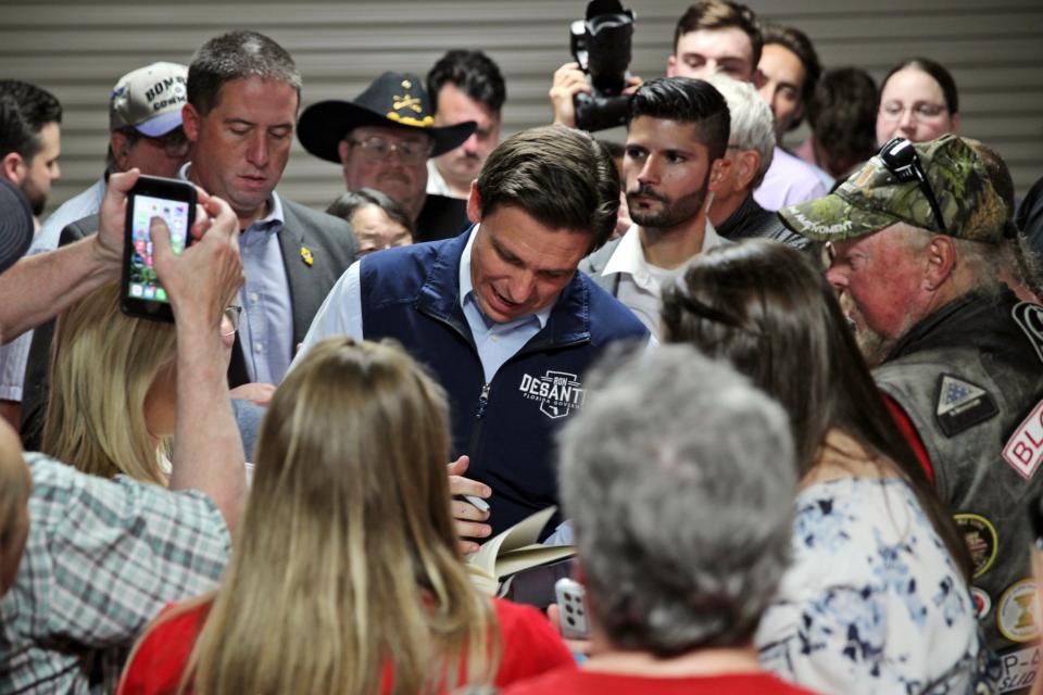 Florida Gov. Ron DeSantis signs an autograph after giving a speech at a rally in Council Bluffs, Iowa, Wednesday. Several hundred people filled half of an event center to listen to DeSantis speak in his first trip to Iowa since announcing his presidential campaign. (AP Photo/Josh Funk)