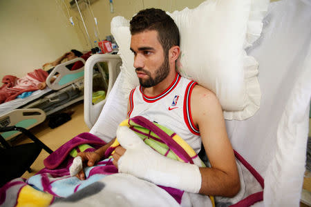 A wounded fighter, who was injured during a truck bomb explosion at Abu Grain, lies on a bed inside a hospital in Misrata, Libya May 10, 2016. REUTERS/Ismail Zitouny