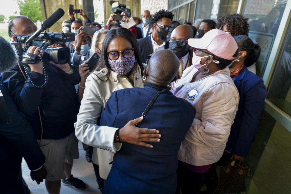 Rochester Mayor Lovely Warren, left, is greeted by supporters after her arraignment in city court in Rochester, N.Y., Monday, Oct. 5, 2020. Warren, who has faced calls to resign over her city's handling of the suffocation death of Daniel Prude at the hands of police, pleaded not guilty Monday to campaign finance charges dating to her 2017 reelection campaign. (AP Photo/Adrian Kraus)